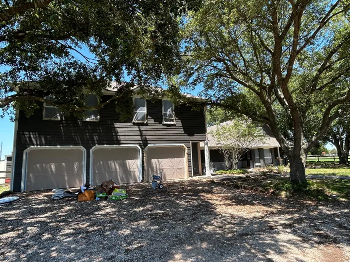 Close-up of exterior siding prep before painting on a Houston home