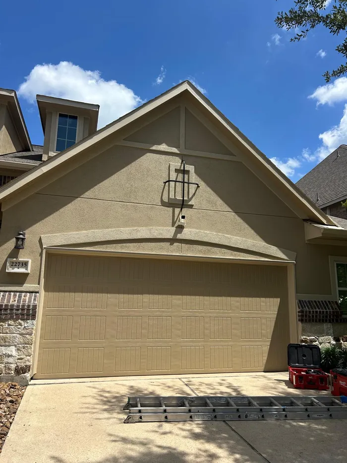 Covered porch furniture staged during an exterior painting job