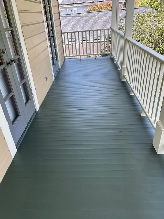 Freshly painted porch flooring in green and cream tones
