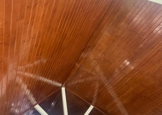 Finished stained wood ceiling of a covered patio addition on a Houston home