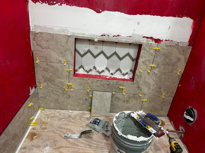 Bathroom shower tile installation in progress